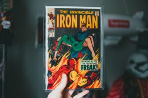 Dłoń trzymająca stary zeszyt komiksu The Invincible Iron Man w ochronnej folii